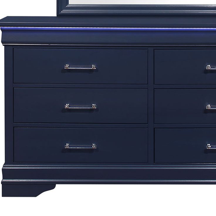 a blue dresser with a mirror on the top and bottom drawer, in front of a white background