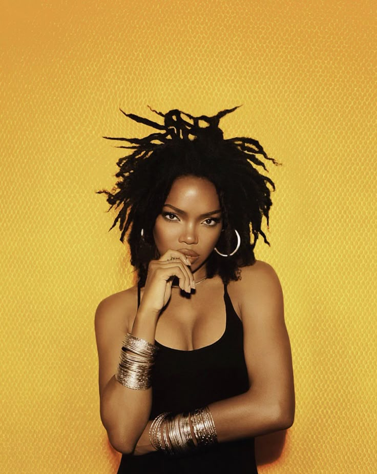 a woman with dreadlocks is posing for a magazine cover photo in front of a yellow background