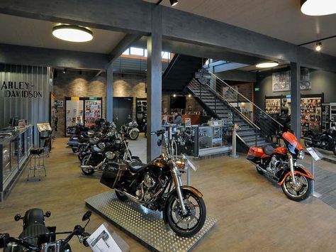 the inside of a motorcycle shop with many motorcycles parked in it's display area