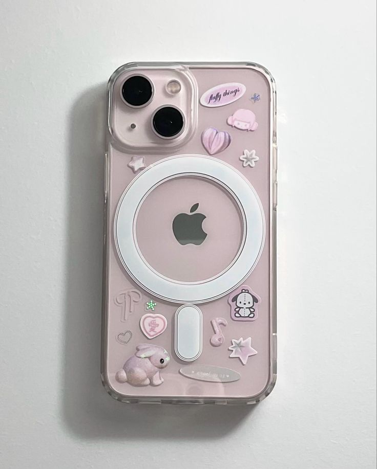 an iphone case with various stickers and buttons on the back, sitting on top of a white surface