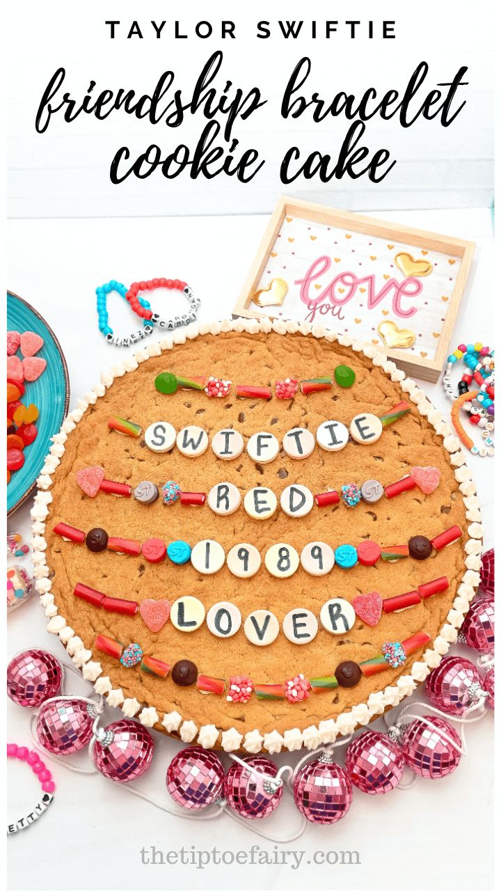 a cookie cake with the words friends in white letters on it and some candies around it