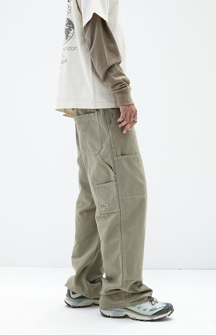 Discover practicality and style in PacSun's Olive Extreme Baggy Carpenter Jeans. Featuring utility pockets, a signature woven tag, spacious back pockets, and side entry pockets, these jeans are designed in an olive wash with durable seams. They boast a baggy fit with a wide leg opening for a relaxed, comfortable silhouette that merges utility with contemporary fashion.


	Model is wearing size 32
	Model Measurements: 6'0” Height, 28" Waist, 34” Chest, 32” Hips Baggy Jeans Design, Jeans Back Pocket Design, Baggy Pants Fashion, Cargo Pants Men Fashion, Carpenter Pants Outfit, Baggy Tshirt, Mens Bottoms, Utility Wear, Baggy Carpenter Jeans