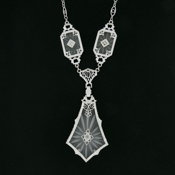 "This is a magnificent antique pendant necklace that was crafted during the art deco period in solid 14k white gold. It features three camphor glass panels with the largest dangling at the center, and each is set with a fine old single cut diamond that adds a lovely touch of sparkle to this piece. The camphor glass displays magnificent etching designs and is elegantly bezel set and framed with etched patterns throughout and further adorned with lovely floral filigree work. The largest camphor gl Luxury Art Deco Necklace With Polished Finish, Victorian White Gold Pendant Necklace, Art Deco Platinum Necklace With Diamond Cut, Silver Art Deco Diamond Necklace, Victorian White Gold Medallion Necklace, Art Deco White Gold Platinum Necklace, Victorian White Gold Necklaces For Evening, Victorian White Gold Necklace For Evening, Victorian Style White Gold Necklace For Evening