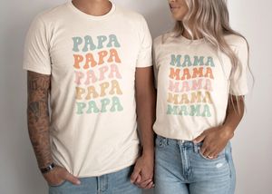 two people standing next to each other wearing matching t - shirts that say papa and mama