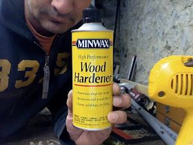 a man is holding a spray can of wood hardener