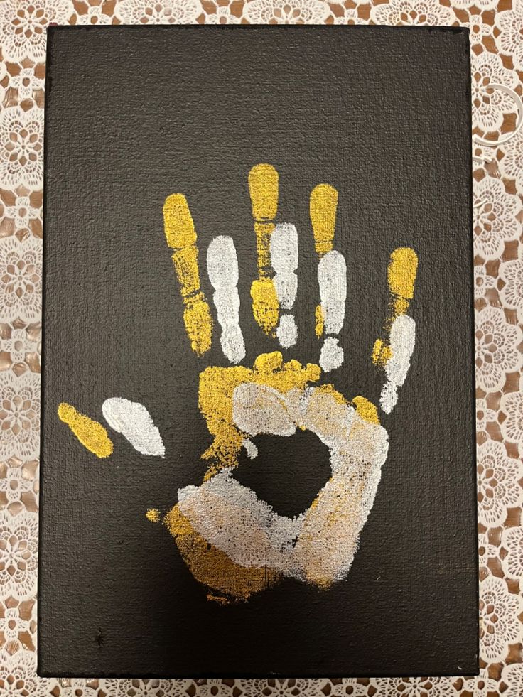 a hand painted with yellow and white paint