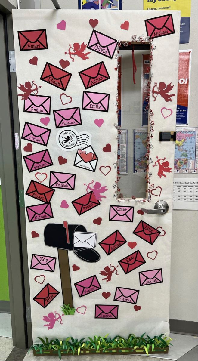 a door decorated to look like an envelope with hearts and letters on it, in the shape of a mailbox