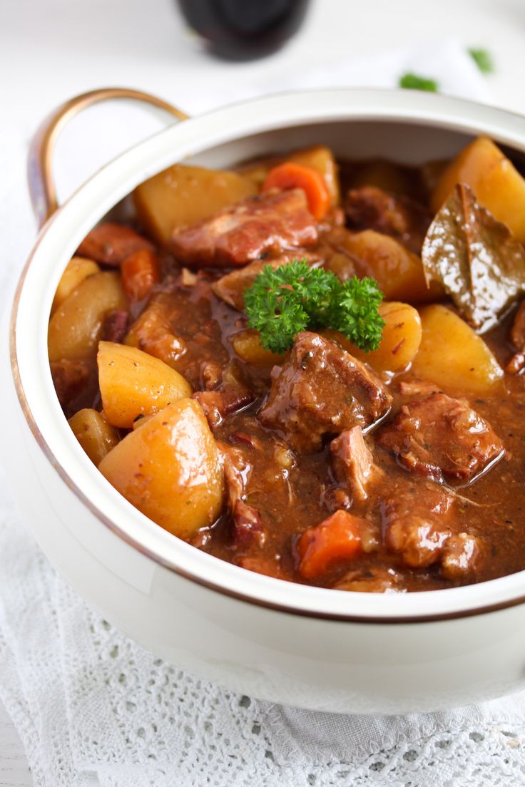 slow cooker lamb casserole with potatoes and carrots in a white bowl