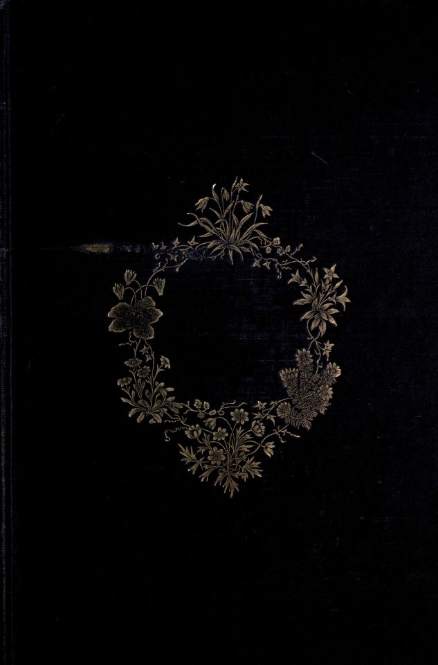 the front cover of a black book with gold flowers on it and a circle in the middle