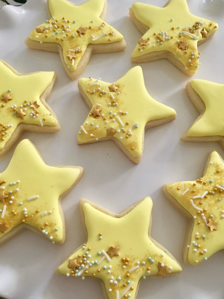 decorated cookies arranged in the shape of stars on a plate