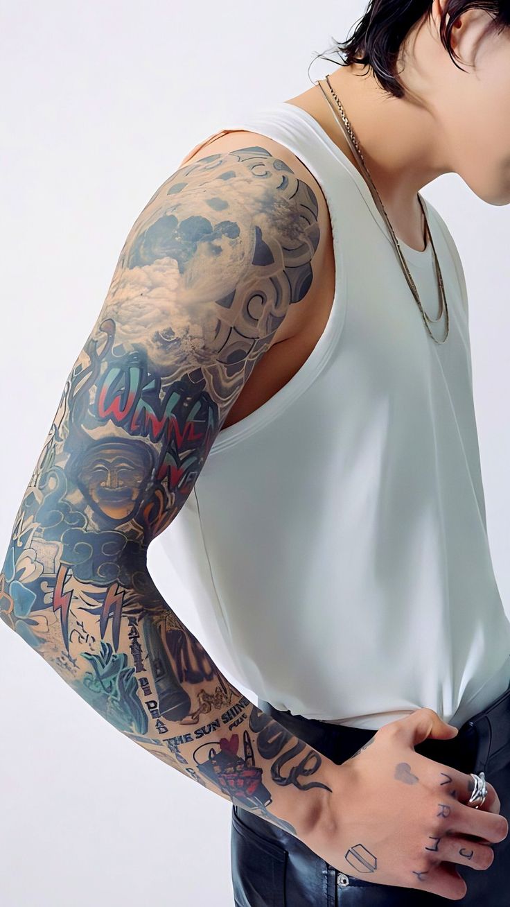 a man with tattoos on his arms and shoulder