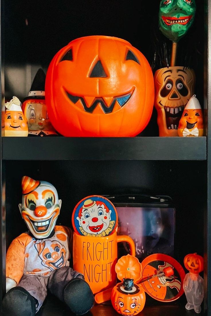 two shelves filled with halloween decorations and pumpkins