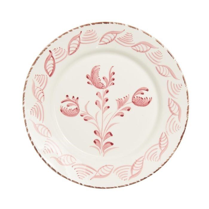 a pink and white plate with leaves on it