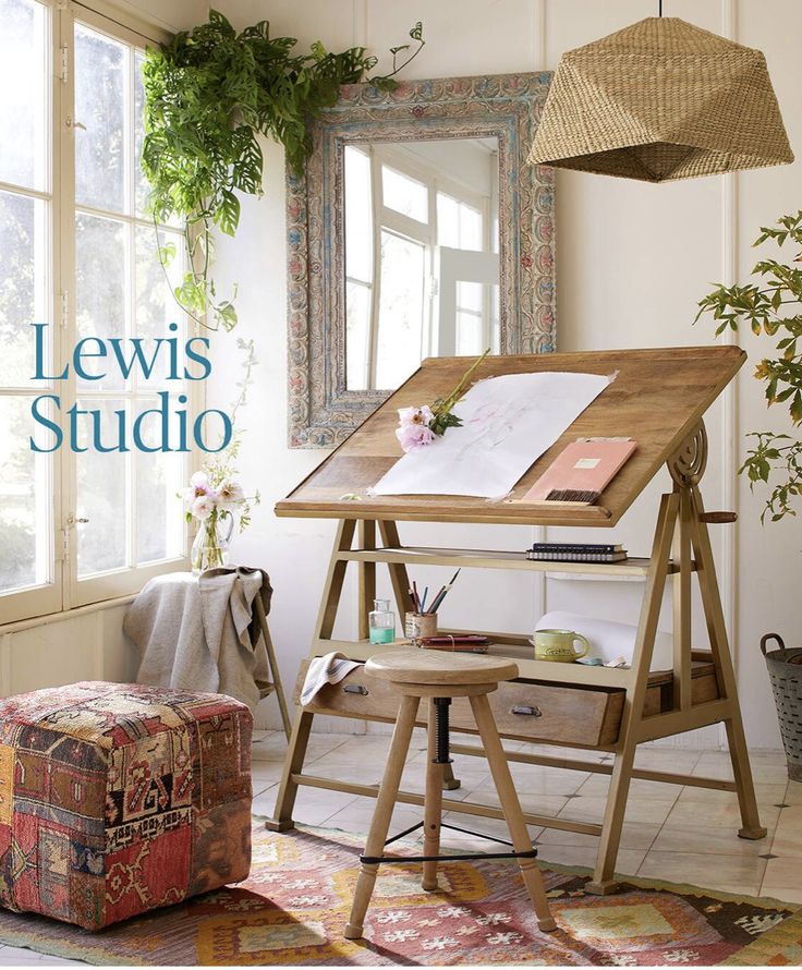 the front cover of lewis studio magazine, featuring an easel and desk with flowers on it