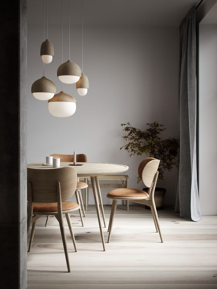 a dining room table with chairs and lights hanging from the ceiling