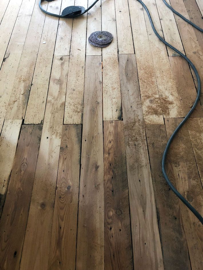 a hard wood floor is being cleaned with a power washer and blow dryer