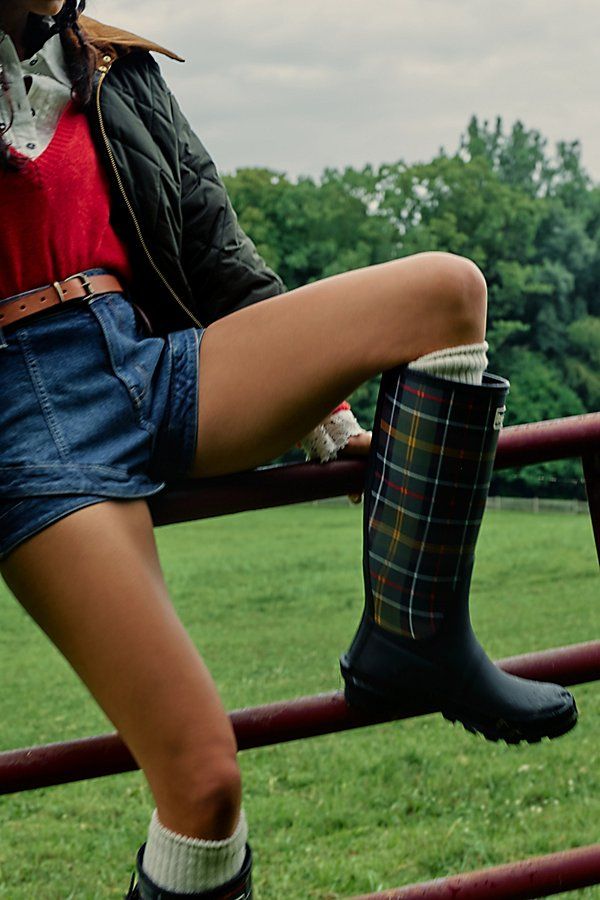 Find BARBOUR Tartan Bede Boots on Editorialist. Stay protected from the rain in timeless style with these tartan-adorned rain boots from Barbour. **Features:** Knee-high length, all-rubber uppers, round toe, tartan-adorned shaft, adjustable buckle detail, tread outsole **Why We Barbour Tartan Bede Boots in Black/Classic Tartan, Size: US 7 Rain Boot Dress Outfit, Barbour Outfit Street Styles, Hunter Boots Outfit Summer, Vintage Fall Outdoor Boots, Tall Rain Boots Outfit, Ll Bean Boots Outfit, Traveler Clothes, Short Hunter Boots Outfit, Hunter Boots Outfit Fall