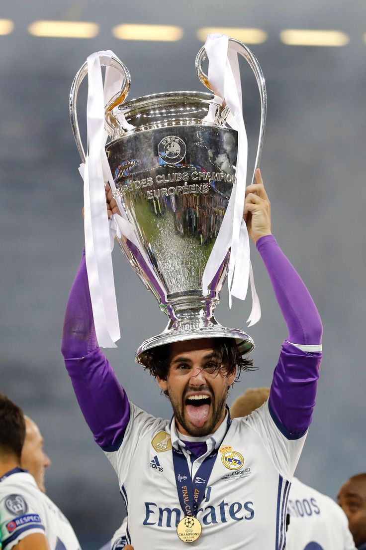 a soccer player holding up a trophy in the air