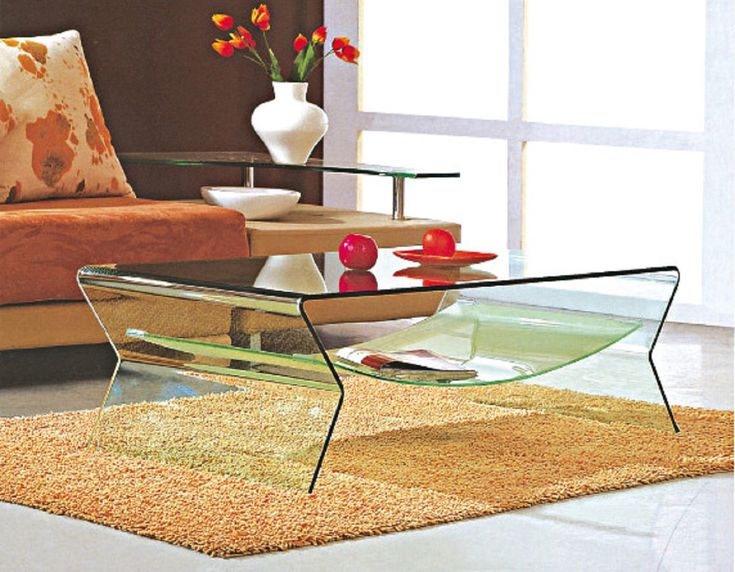 a glass coffee table sitting on top of a rug