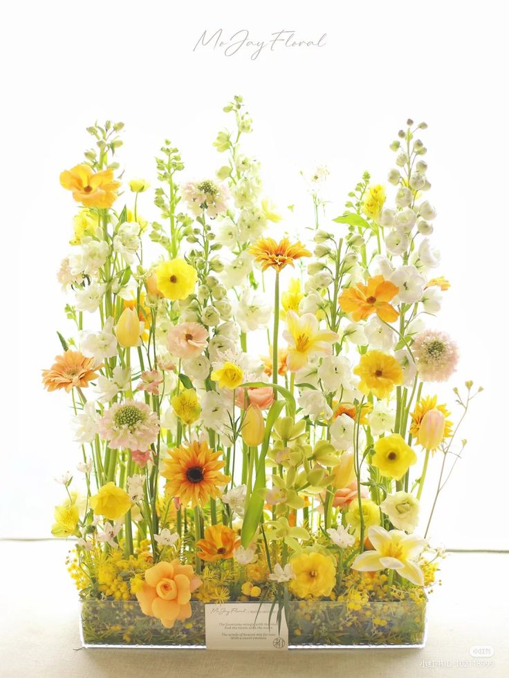 a bunch of flowers that are in some kind of potted planter on a table