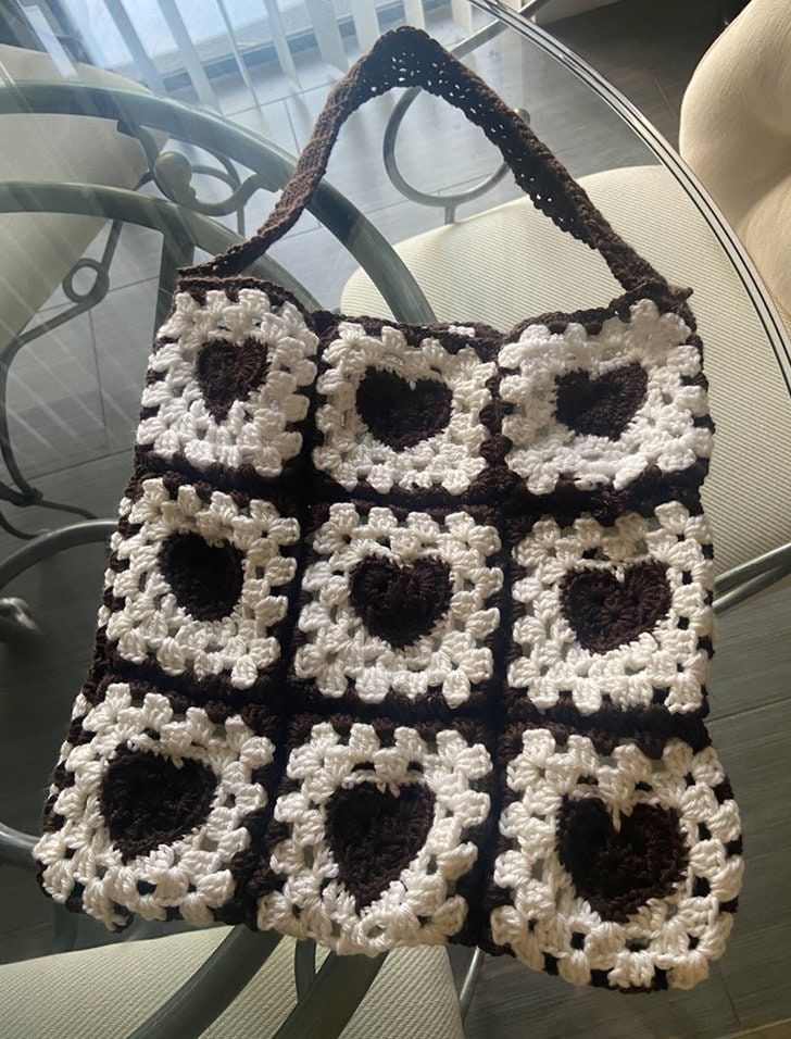 Brown and white large tote bag with heart motifs. The bag is very trendy and the perfect accessory for any outfit. This tote is very sturdy and can hold all of your needs. Personalization can be added to the bag by choosing the color and length of the strap, prices may vary depending on the customization. Trendy Everyday Shoulder Bag With Heart Print, Large Capacity White Crochet Bag For Shopping, Trendy Heart Print Shoulder Bag For Everyday, Trendy White Crochet Bag With Large Capacity, White Crochet Bag With Double Handle, Trendy Large Capacity White Crochet Bag, Trendy White Crochet Bag For Daily Use, Trendy White Heart-shaped Shoulder Bag, White Crochet Tote Bag Large Capacity