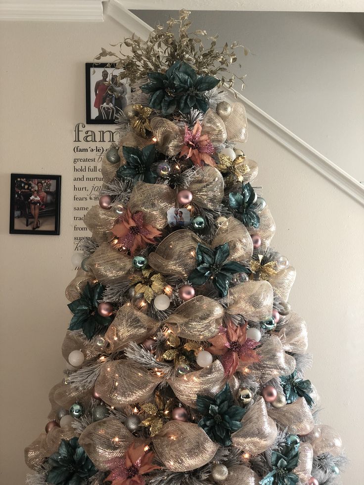 a christmas tree decorated with silver and pink ornaments