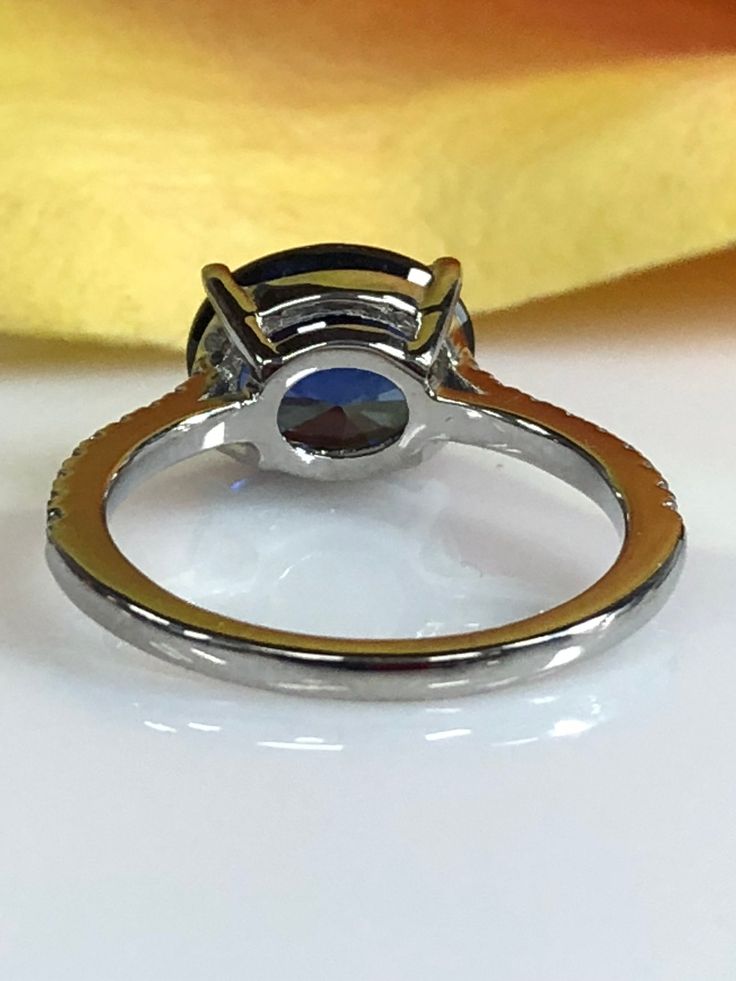 "Beautiful Oval Blue Sapphire And Genuine Diamond Ring Set Horizontal In 14k White Gold #5777 Rose Gold is available upon request as a custom order and is a final sale (non refundable, non returnable, non exchangeable) Center Stone: Gem Type: Lab Created Sapphire Shape: Oval Shape Weight: 10x8mm Diamond Equivalent: 3.00ctw. Color: Blue, Medium Blue Hardness: 9 (Moh's scale) Accents Stone: Gem Type: Genuine Diamonds Shape: Round Brilliant / 18 Weight: .18ctw. Color: G Clarity: SI1 Hardness: 10 (M Round Sapphire Fine Jewelry, White Gold Multi-stone Sapphire Ring, White Gold Multi-stone Sapphire Ring With Round Cut, Round Sapphire Gemstones For Fine Jewelry, Anniversary Brilliant Cut Round Gemstones, Oval Sapphire Gemstone With Halo Setting, Classic Round Gemstones With Center Stone, Oval Halo Ring With Multi-stone Diamond, Platinum Multi-stone Round Cut Rings