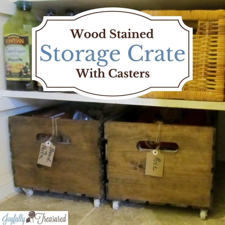 wooden storage crate with casteors and tags on the bottom shelf in a kitchen area