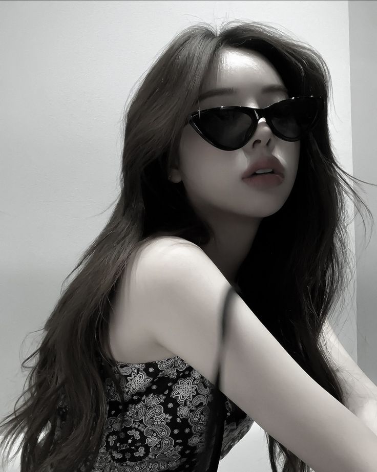 a woman with long dark hair wearing sunglasses