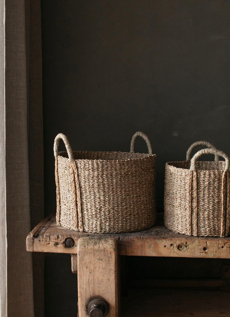 two baskets sitting on top of a wooden table