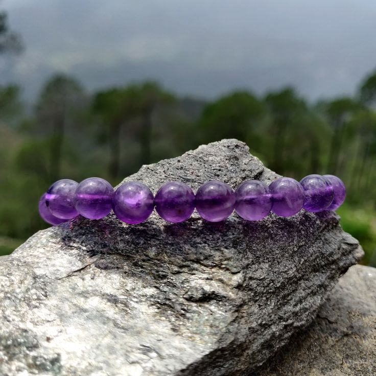 Discover the beauty and power of our handmade, adjustable Amethyst Macrame bracelet, designed to fit both men and women perfectly. Crafted with intention, this bracelet features Amethyst crystals, believed to be a powerful stone that provides protection, stress relief, and spiritual growth. As the February birthstone, it makes a meaningful gift for a loved one or a special treat for yourself! '¨) ¸.*'¸.*'¨) ¸. (¸.*' (¸.*` ♥ *FREE INTERNATIONAL SHIPPING ►► Use the drop-down menu to select your preferred option:  ► 6mm Beads Bracelet ► 8mm Beads Bracelet ►► Thanks to the drawstring closure, the bracelet's circumference adjusts from a minimum of 7.5'' (20cm) to a maximum of 10.5'' (27cm). ►►The wax black cord is 100% vegan, durable, and safe for showering and swimming. ►► Each bracelet featur Amethyst Gemstone Beads Bracelets As Gift, Amethyst Stretch Bracelet With Round Beads For Gift, Amethyst Stretch Bracelet With 8mm Beads As Gift, Adjustable Purple Spiritual Bracelets, Adjustable Amethyst Crystals With Natural Stones, Amethyst Beaded Bracelet For Meditation, Adjustable Amethyst Stretch Bracelet With Round Beads, Adjustable Purple Crystal Spiritual Bracelet, Adjustable Amethyst Crystal Bracelet Gift