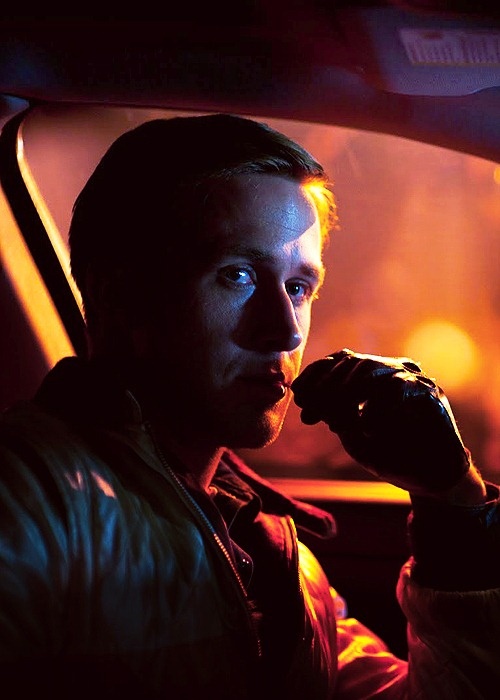 a man sitting in the passenger seat of a car with his hand on his chin