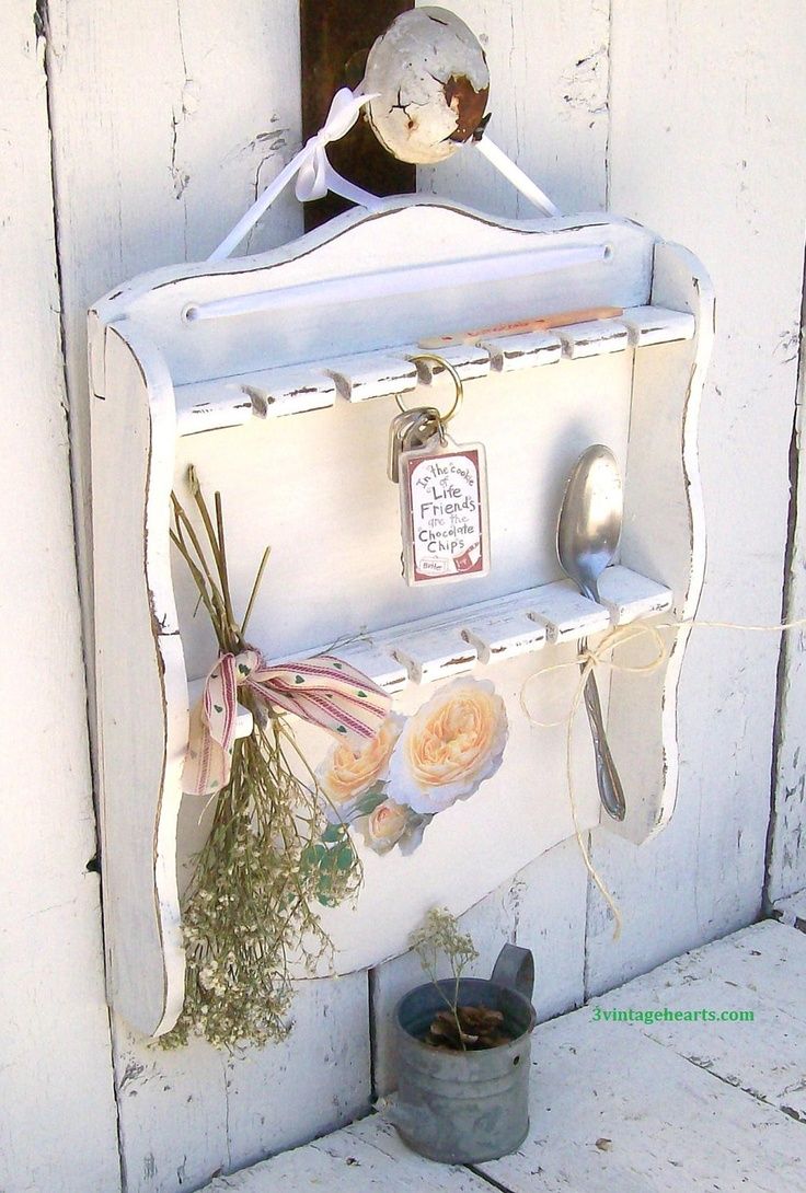 an old white shelf with some flowers on it