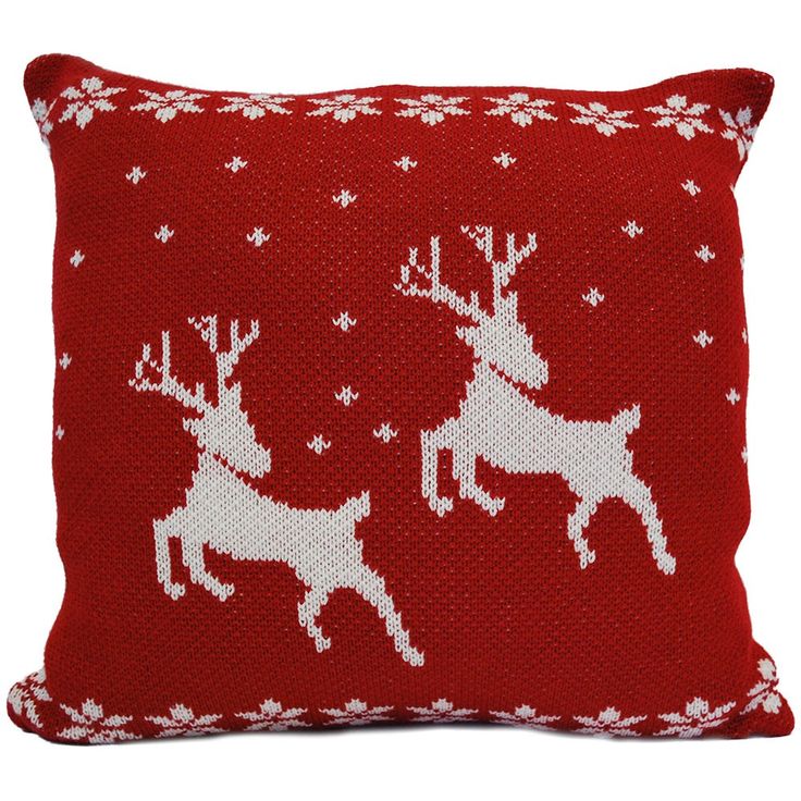 a red pillow with white reindeers on it