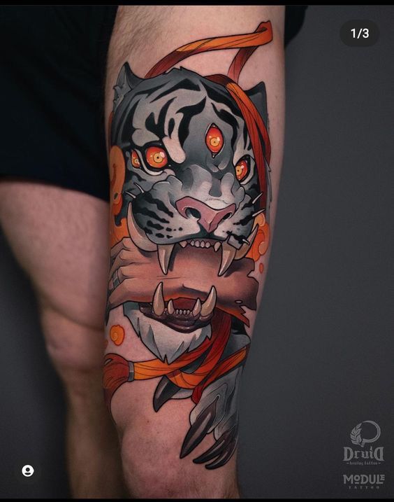 a man with a tiger tattoo on his arm and leg is holding an orange ribbon