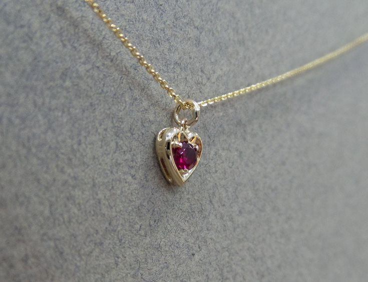 Ruby Necklace/ 14k Gold Heart Necklace/ Mini Heart Necklace/ Dainty Heart Necklace/ Gemstone Necklace/ July Birthstone/ Birthday Gift/ Valentines Gift/ Delicate Ruby Necklace Free Shipping within the USA METAL: 14K YELLOW GOLD 585 STONES: 0.12CT GENUINE RUBY STYLE: MINI HEART NECKLACE/ JULY BIRTHSTONE PURITY: 14K 585 SIZE: HEART IS 6.3MM BY 6.5MM AS IT IS WITH THIS ITEM ALL MY PIECES ARE HAND MADE. AND I STAND BEHIND EVERY PIECE. SATISFACTION GUARANTEED. FIND OUT ABOUT OUR LAYAWAY PAYMENT PLAN A Dainty Red Heart Necklace With Heart Charm, Red Ruby Heart Necklace, Elegant Red Gemstone Heart Necklace, Yellow Gold Ruby Heart Pendant Necklace, Ruby Heart Necklace, Heart-shaped Ruby Necklace In Yellow Gold, Heart Pendent, Ancient Greek Jewelry, Indie Jewelry