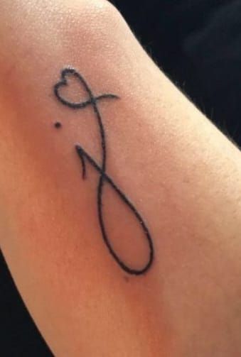 a tattoo on the arm of a woman with a heart and an x in it