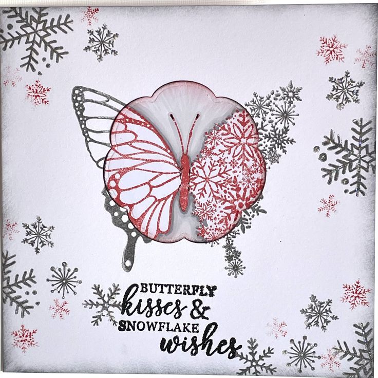 a card with a butterfly and snowflakes on the bottom, in red and white