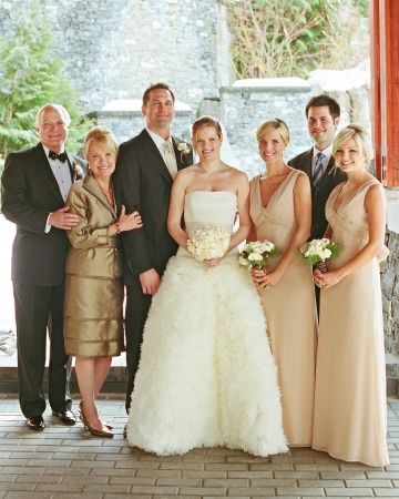 a group of people standing next to each other in front of a stone wall and doorway