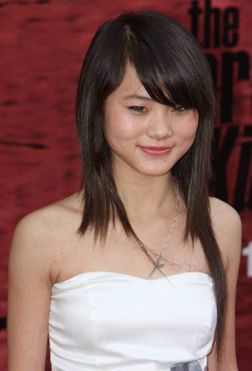 a woman with long hair wearing a strapless white dress