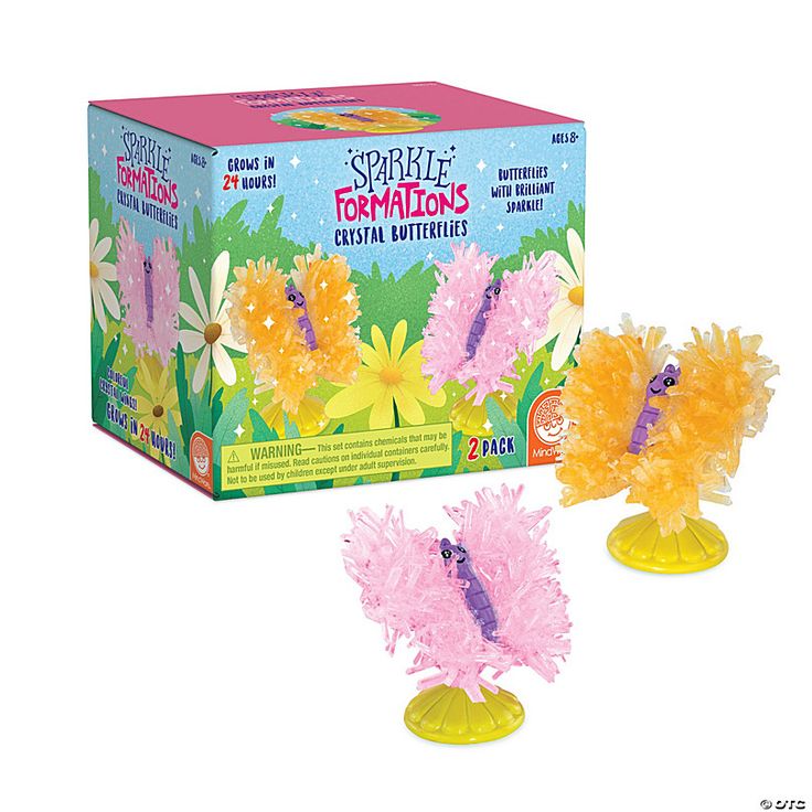 two plastic toys in front of a box on a white background with an image of flowers