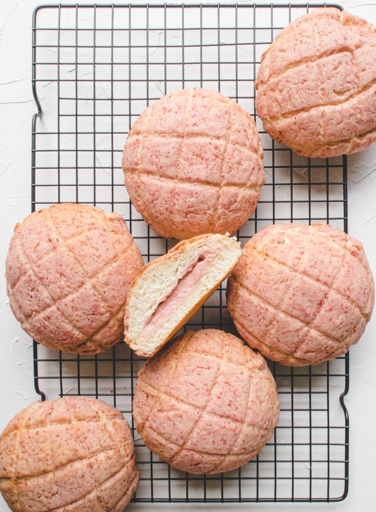 strawberry and cream cheese pineapple buns on a cooling rack with text overlay