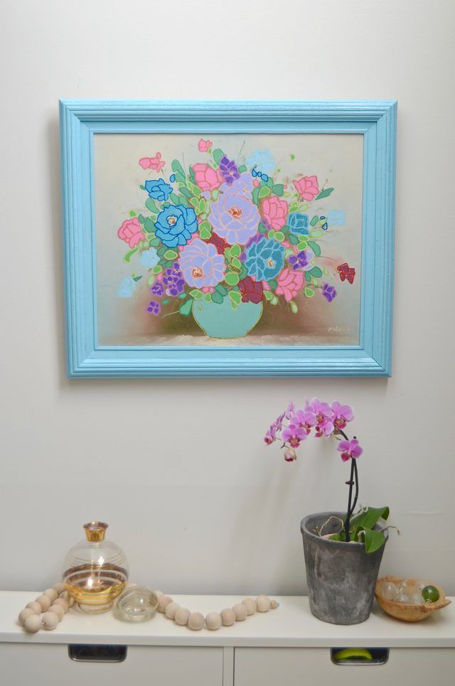 there is a painting on the wall with flowers in it