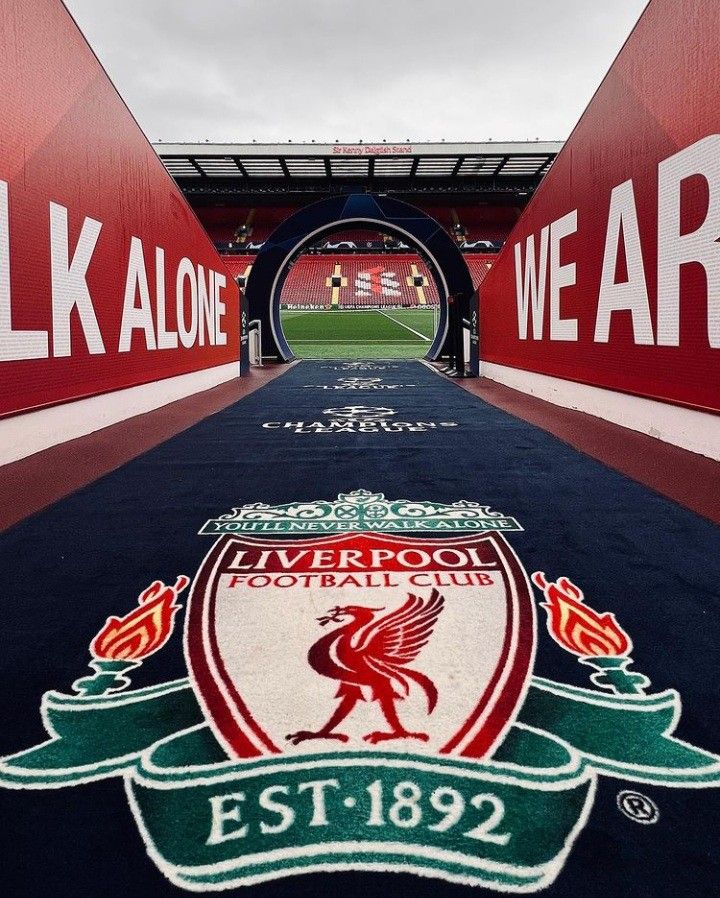 the liverpool football club logo is painted on the ground in front of an empty stadium