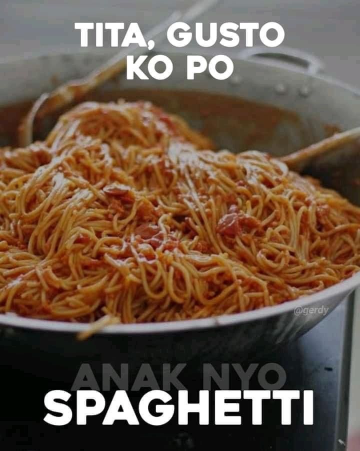 a large pot filled with spaghetti on top of a stove