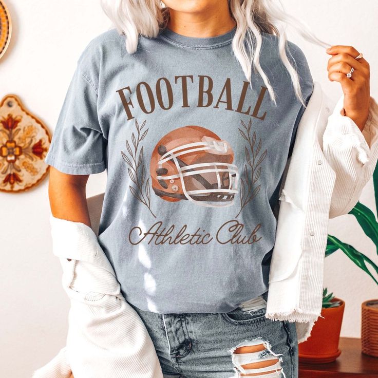 Get ready for game day with our Football Athletic Club Comfort Color Tee, designed for those who love a mix of comfort and style. This tee is perfect for expressing your team pride with a laid-back vibe. Featuring the iconic emblem of our Football Athletic Club, this shirt radiates team spirit and unity. Whether you're in the stadium or cheering from your couch, this tee lets you support your team with flair. Crafted from high-quality materials, it ensures exceptional comfort and long-lasting we Sporty Top With Team Logo For Sports Season, Sports Fan Tops With Team Logo For Game Day, Casual Top With Team Logo For Baseball Season, Casual Tops With Team Logo For Game Day, Casual Tops For Baseball Season Fan Gear, Football Season Tops With Team Logo For Sports Fans, Sports Fan Tops With Team Logo For Football Season, Sports Tops With Team Name For Football Season, Sports Fan Tops With Team Logo For Baseball Season