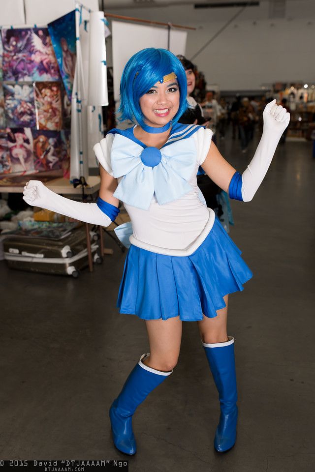 a woman dressed in blue and white posing for the camera