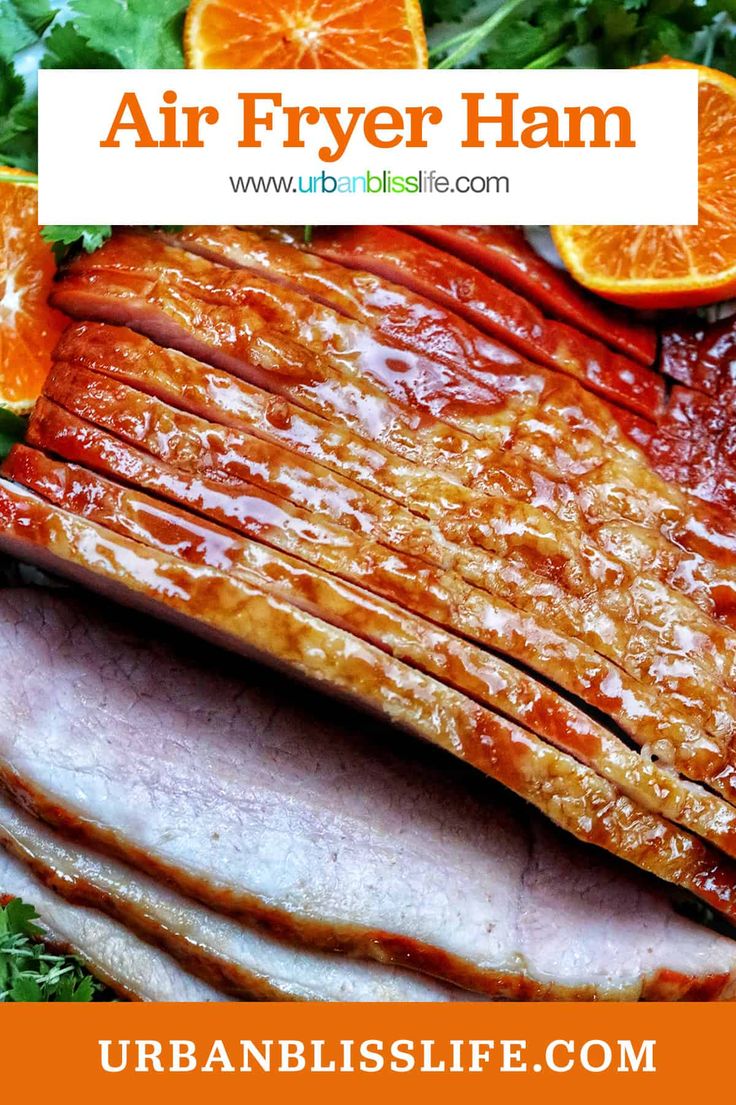 an air fryer ham with oranges and greens on the side is featured in this image