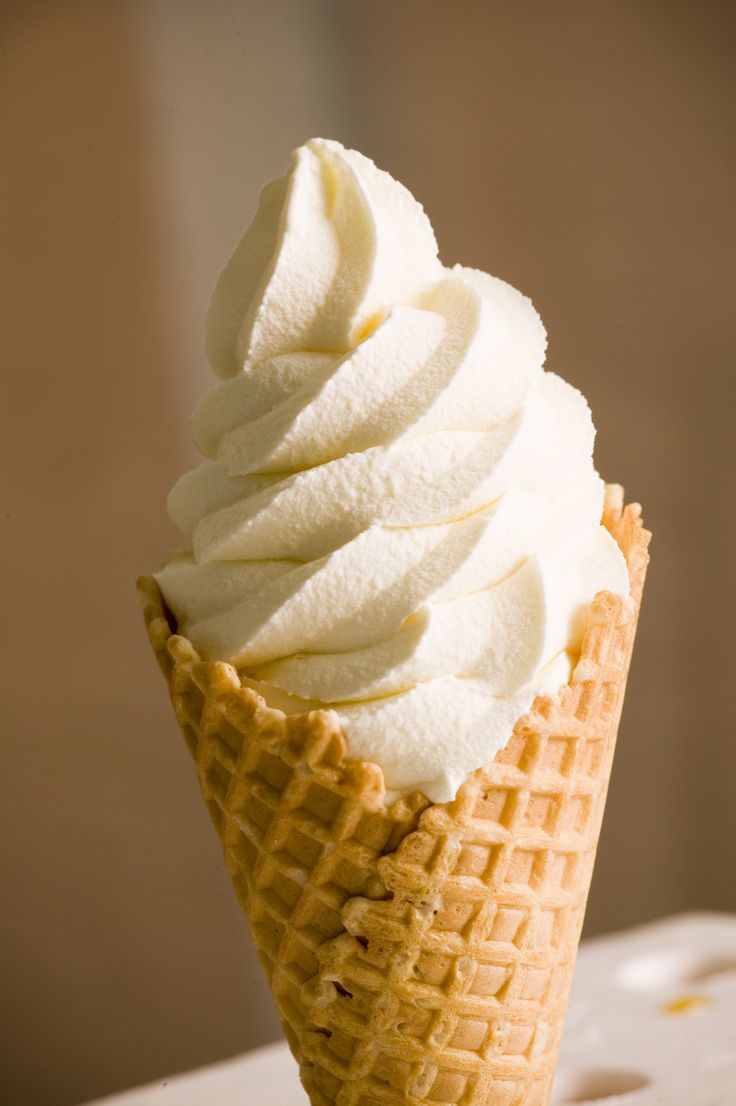 an ice cream cone with white icing on top