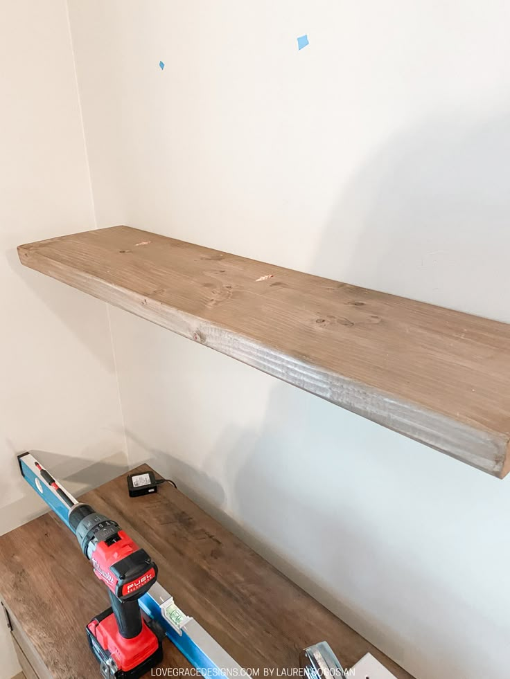 a work bench with tools on it in a room that has been painted white and is being worked on